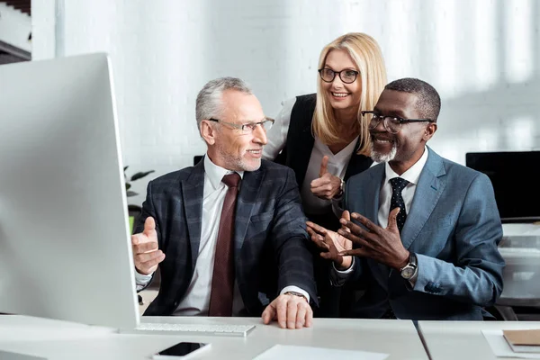 Happy Blonde Woman Glasses Showing Thumb Multicultural Partners — Stock Photo, Image