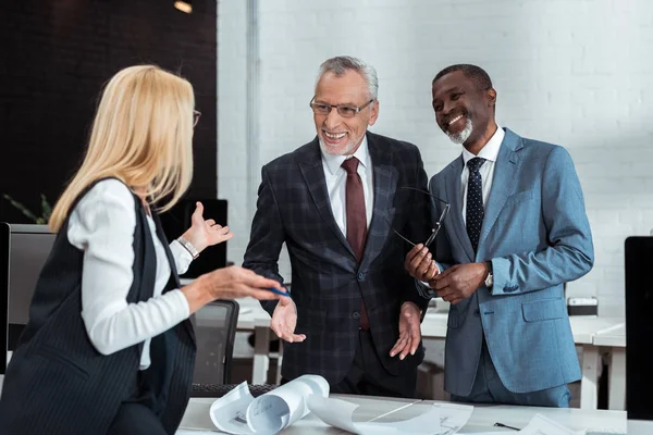 Selective Focus Cheerful Multicultural Businessmen Smiling While Looking Blonde Partner — Stock Photo, Image