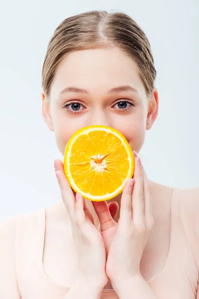 灰色で隔離された口の前で熟したオレンジを保持する十代の少女 — ストック写真