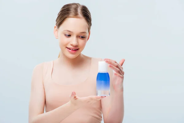 Sonriente Bonita Adolescente Mirando Cosmética Loción Aislado Gris — Foto de Stock