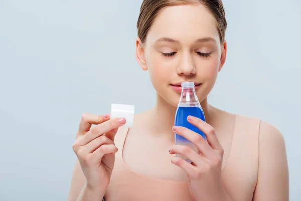 Smiling Teenage Girl Closed Eyes Smelling Cosmetic Lotion Isolated Grey — Stock Photo, Image