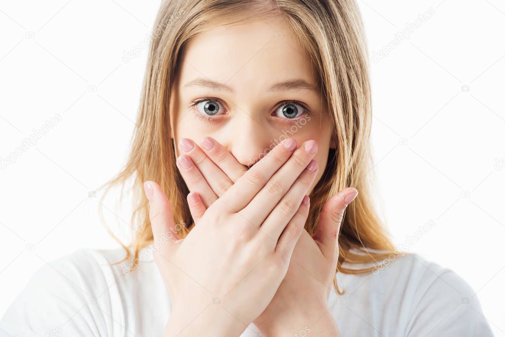 scared teenage girl covering mouth with hands isolated on white