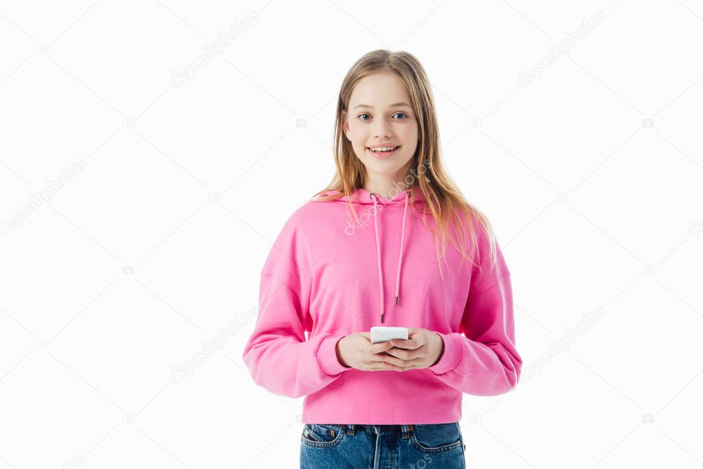 happy teenage girl in pink hoodie holding smartphone isolated on white
