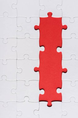 top view of white connected ans incomplete jigsaw puzzle pieces isolated on red  clipart