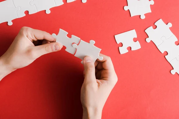 Cropped View Man Holding White Puzzle Pieces Hands Red — Stock Photo, Image