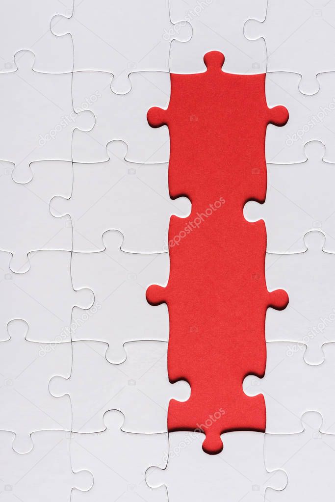 top view of white connected ans incomplete jigsaw puzzle pieces isolated on red 