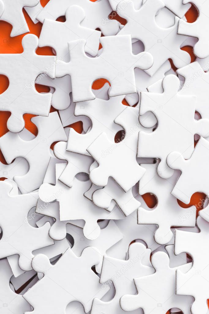 close up of incomplete white jigsaw puzzle pieces