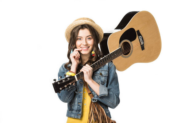 smiling hippie girl holding acoustic guitar isolated on white