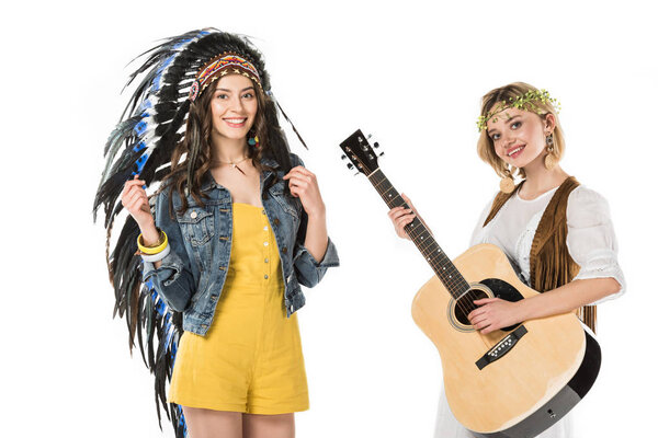 two bisexual hippie girls in indian headdress and wreath with acoustic guitar isolated on white