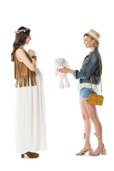 Side View Hippie Girl Giving Toy Rabbit Pregnant Girlfriend Isolated — Stock Photo, Image