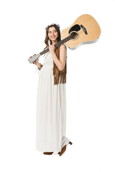 full length view of smiling pregnant hippie woman holding acoustic guitar isolated on white
