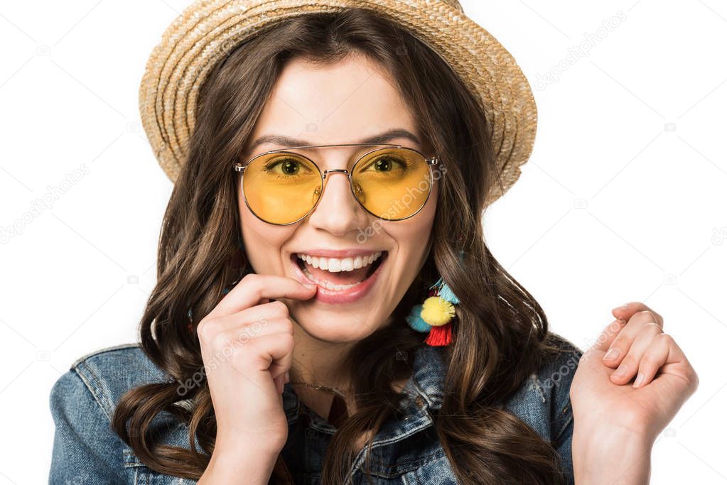 front view of smiling boho girl in sunglasses and boater looking at camera isolated on white