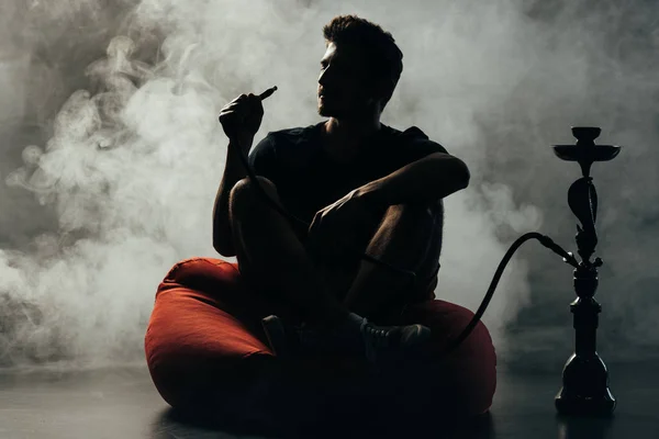 Silhouette Man Sitting Bean Bag Chair Smoking Hookah — Stock Photo, Image