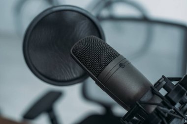 selective focus of microphone with membrane in radio studio clipart