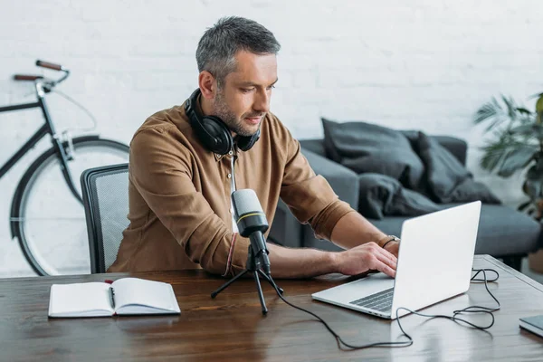 Anfitrião Rádio Atencioso Usando Laptop Enquanto Sentado Local Trabalho Perto — Fotografia de Stock