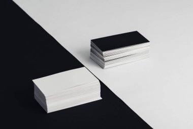 stacks of white and black empty business cards on black and white background clipart