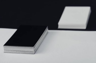 stacks of empty business cards on black and white background clipart