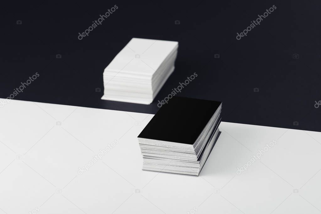 stacks of empty business cards on divided black and white background