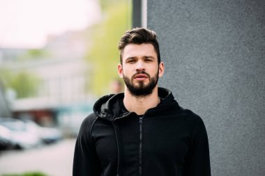 handsome bearded man in sportswear looking at camera clipart