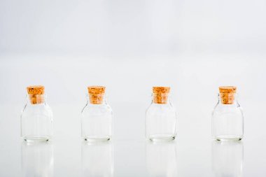 empty corked glass jars on white background with copy space clipart
