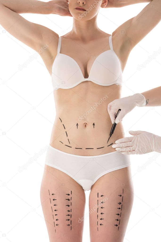 partial view of plastic surgeon in latex gloves making marks on body isolated on white