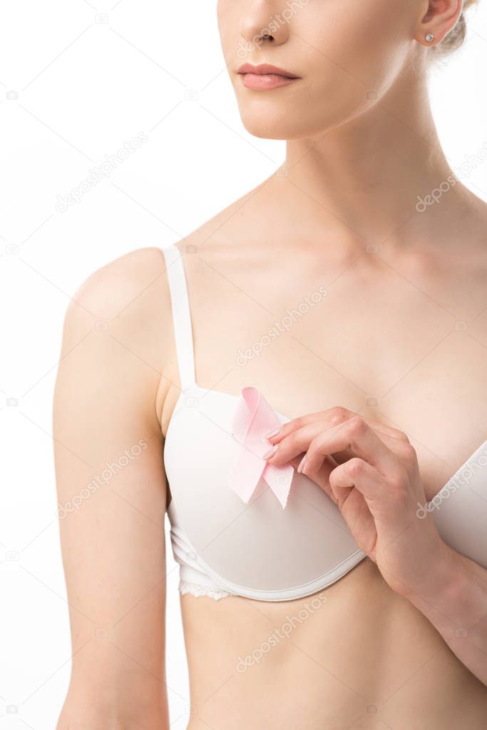 cropped view of woman in bra holding pink ribbon isolated on white