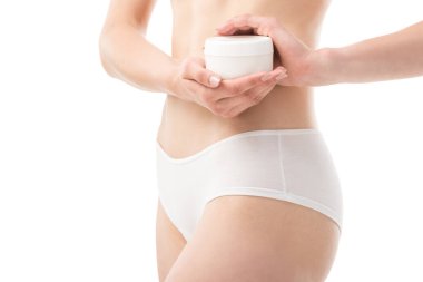 beyaz izole kozmetik krem tutan iç çamaşırı genç kadının kırpılmış görünümü