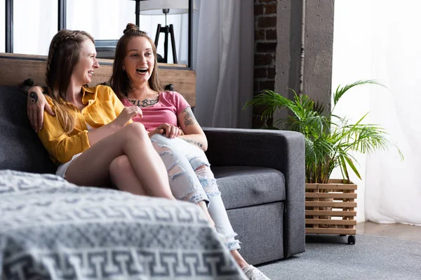 Two Pretty Lesbians Embracing While Sitting Sofa Living Room — Stock Photo, Image