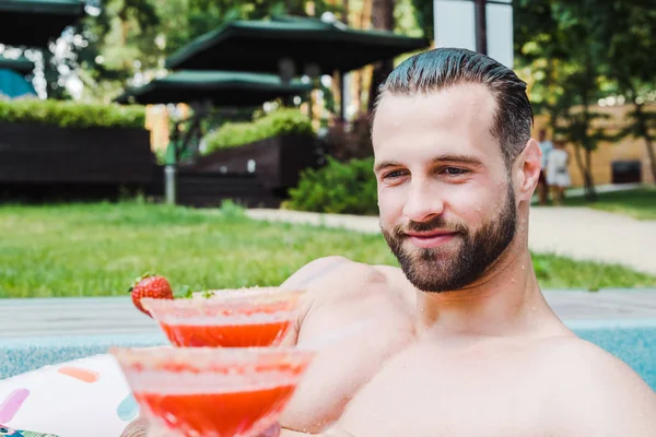 Handsome Bearded Man Smiling While Looking Red Cocktail — Stock Photo, Image