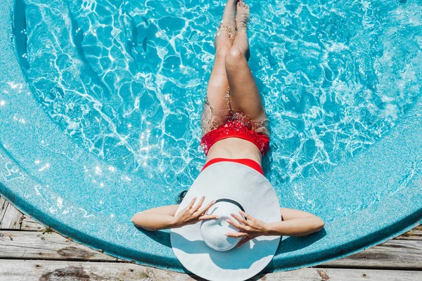 Top View Woman Touching Straw Hat Sitting Red Swimsuit Blue — Stock Photo, Image