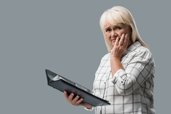 Upset Retired Woman Holding Photo Album Touching Face Isolated Grey — Stock Photo, Image