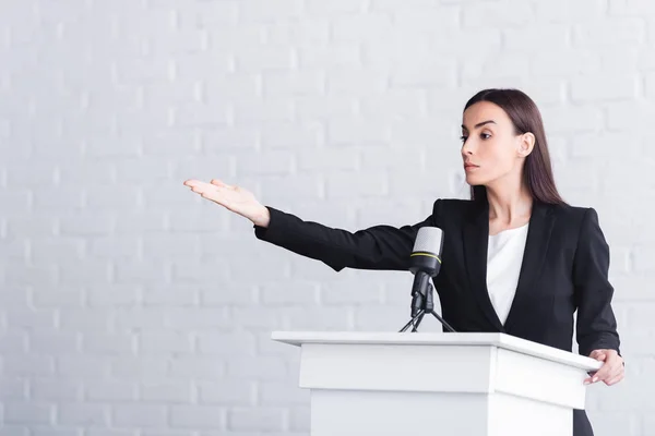 Attractive Confident Lecturer Pointing Hand While Standing Podium Tribune — Stock Photo, Image