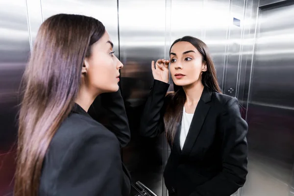 Attractive Businesswoman Looking Reflection Elevator Touching Eyelashes — Stock Photo, Image