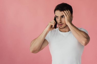 beyaz t-shirt karışık kaslı adam pembe izole akıllı telefon konuşuyor