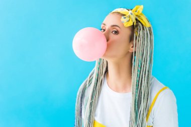 girl with dreadlocks and headband blowing bubblegum isolated on turquoise clipart