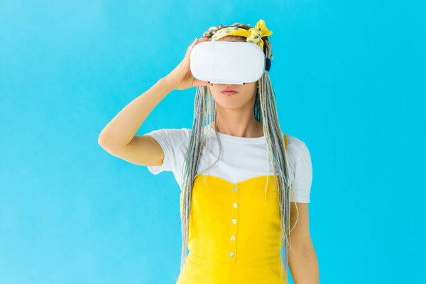 girl with dreadlocks in virtual reality headset isolated on turquoise