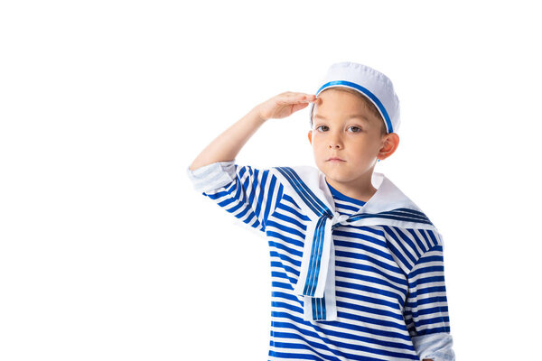serious preschooler child in sailor costume saluting and looking at camera isolated on white
