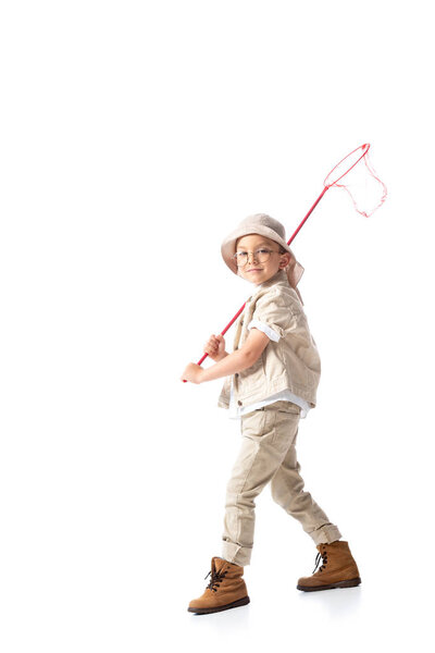 full length view of explorer kid in hat holding butterfly net isolated on white