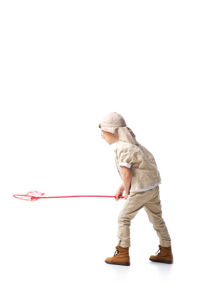 side view of explorer kid in hat holding butterfly net isolated on white