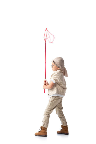 full length view of explorer boy in glasses holding butterfly net on white