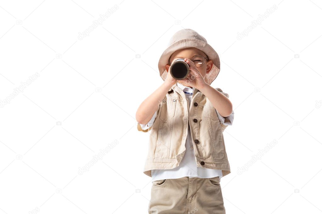 explorer boy in glasses and hat looking through spyglass isolated on white