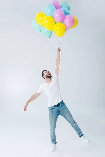 Excited Man Casual Clothes Holding Colorful Balloons Grey — Stock Photo, Image