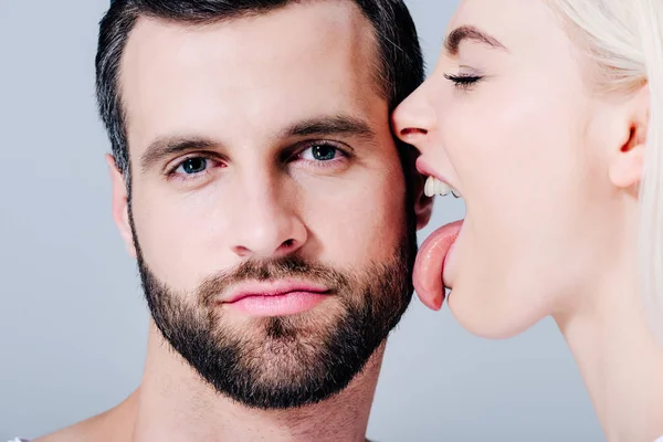 Young Woman Licking Face Man Looking Camera Isolated Grey — Stock Photo, Image