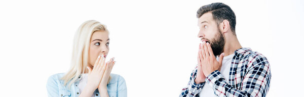 panoramic of surprised girl and man covering mouths Isolated On White