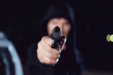 siyah hoodie hırsız elinde silah seçici odak 