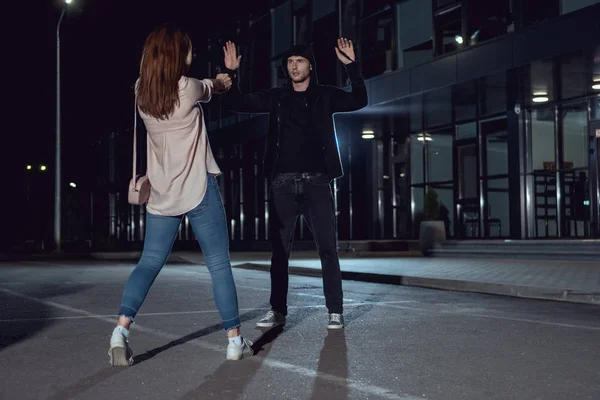 Woman Pointing Gun Thief Hands Air Parking Lot — Stock Photo, Image