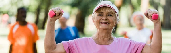 Panoramic Shot Cheerful Senior Woman Cap Holding Dumbbells While Exercising — Stock Photo, Image