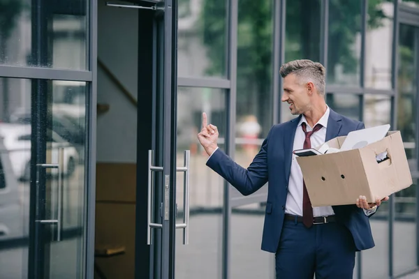 Handsome Man Suit Showing Middle Finger While Holding Box — Stock Photo, Image