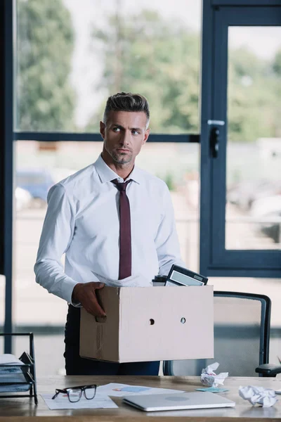 Serious Businessman Holding Box While Standing Workplace — Stock Photo, Image