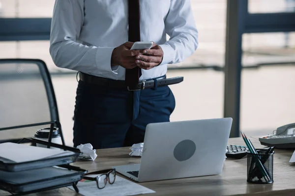 Cropped View Businessman Using Smartphone Laptop Office Royalty Free Stock Photos